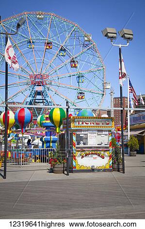 Stock Photograph - Wonder Wheel and the boardwalk at an amusement park on Coney Island; New York, United States of America. Fotosearch