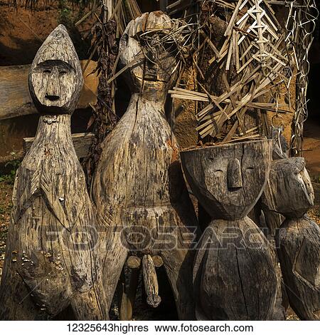 Stock Photograph - Wooden carvings in human likeness; Tambon Mae Salong Nok, Chang Wat Chiang Rai, Thailand. Fotosearch