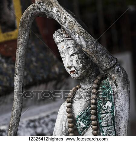 Stock Photograph - Worn and weathered buddhist sculpture; Luang Prabang, Luang Prabang Province, Laos. Fotosearch