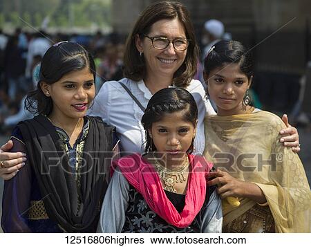Stock Photograph - A caucasian woman posing with three beautiful young Indian women; Mumbai, Maharashtra, India. Fotosearch