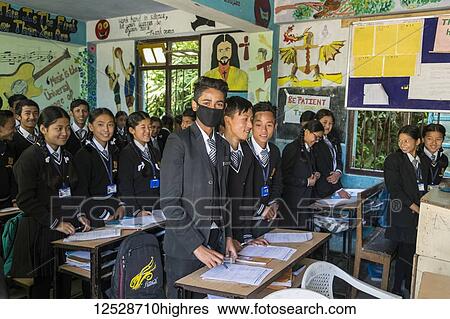 A classroom of teenage students in uniform, one of them wearing a mask over his mouth; Sikkim, India View Large Photo Image Stock Photograph - A classroom of teenage students in uniform, one of them wearing a mask over his mouth; Sikkim, India. Fotosearch