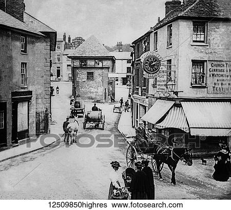Stock Photograph - A clockmaker shop and mechanical clock depicted from a magic lantern slide circa 1900; Faringdon, Oxfordshire, England. Fotosearch