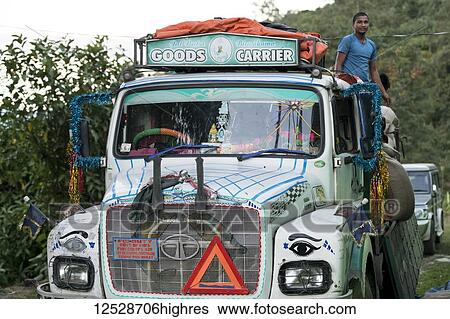 A colourful and decorated transport truck on a road with a worker standing up in the back; Sikkim, India View Large Photo Image Stock Photograph - A colourful and decorated transport truck on a road with a worker standing up in the back; Sikkim, India. Fotosearch