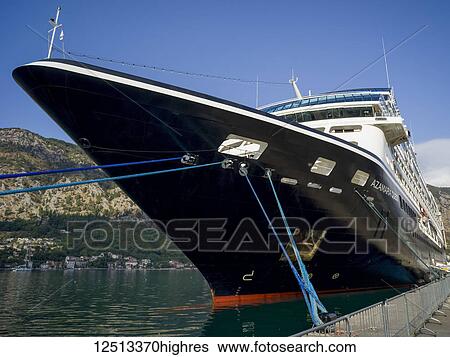 Stock Photograph - A cruise ship mooring in a port in the Bay of Kotor; Kotor, Monte. Fotosearch