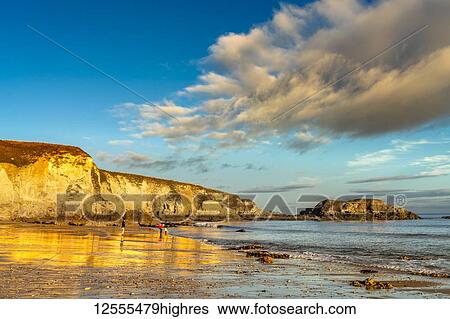 Stock Photograph - A family walks on the beach along the River Tyne and the Atlantic coast; South Shields, Tyne and Wear, England. Fotosearch