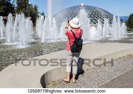 A female tourist takes a photo at Queen Elizabeth Park; Vancouver, British Columbia, Canada View Large Photo Image Stock Photograph - A female tourist takes a photo at Queen Elizabeth Park; Vancouver, British Columbia, Canada. Fotosearch