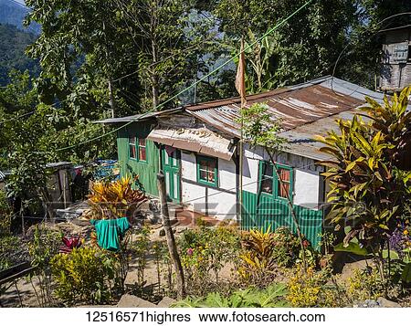 A house with a rusted roof and a clothesline hanging from the trees; West Bengal, India View Large Photo Image Stock Photograph - A house with a rusted roof and a clothesline hanging from the trees; West Bengal, India. Fotosearch