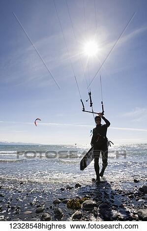 Stock Photograph - A kitesurfer on the beach during an instruction class, Kachemak Bay, South-central Alaska; Alaska, United States of America. Fotosearch