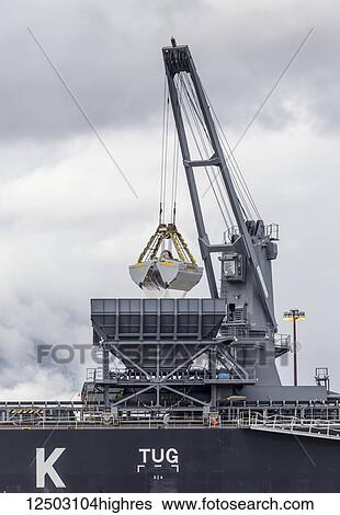A large crane shovel attachment deposits salt into a container ship for export overseas shipment from the Port of Vancouver; Vancouver, British Columbia, Canada View Large Photo Image Stock Photograph - A large crane shovel attachment deposits salt into a container ship for export overseas shipment from the Port of Vancouver; Vancouver, British Columbia, Canada. Fotosearch