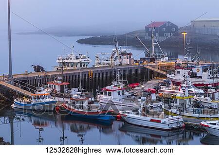 A late night foggy viewpoint of the harbour and fishing docks at Djupivogur, Eastern Iceland where there is still light late in the night when summer soltice is approaching; Djupivogur, Iceland View Large Photo Image Stock Photograph - A late night foggy viewpoint of the harbour and fishing docks at Djupivogur, Eastern Iceland where there is still light late in the night when summer soltice is approaching; Djupivogur, Iceland. Fotosearch