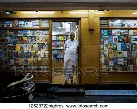 A male shopkeeper stands in the doorway of the bookstore at night; Rishikesh, Uttarakhand, India View Large Photo Image Stock Photograph - A male shopkeeper stands in the doorway of the bookstore at night; Rishikesh, Uttarakhand, India. Fotosearch