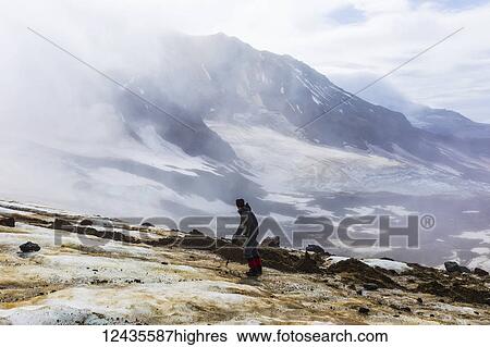 A man looks toward Trident Volcano through clouds while ascending the Knife Creek Glaciers in Katmai National Park; Alaska, United States of America View Large Photo Image Stock Photograph - A man looks toward Trident Volcano through clouds while ascending the Knife Creek Glaciers in Katmai National Park; Alaska, United States of America. Fotosearch