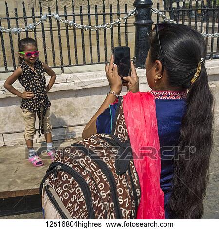 A mother takes a picture of her young daughter as she poses at the Gateway of India, considered a 'symbolic monument' that represents the city of Mumbai; Mumbai, Maharashtra, India View Large Photo Image Stock Photograph - A mother takes a picture of her young daughter as she poses at the Gateway of India, considered a 'symbolic monument' that represents the city of Mumbai; Mumbai, Maharashtra, India. Fotosearch