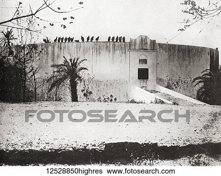 Stock Photograph - A Parsee or Parsi tower of silence aka Dakhma, Bombay, India. A raised structure built by Zoroastrians for excarnation that is, for dead bodies to be exposed to carrion birds, usually vultures. From The Wonders of the World, published c. 1920.. Fotosearch