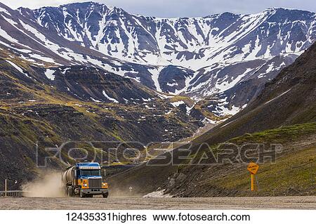 A semi-truck ascends through Atigun Pass along the Dalton Highway; Alaska, United States of America View Large Photo Image Stock Photograph - A semi-truck ascends through Atigun Pass along the Dalton Highway; Alaska, United States of America. Fotosearch