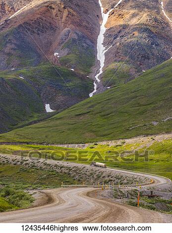 A semi-truck begins the ascent through Atigun Pass along the Dalton Highway; Alaska, United States of America View Large Photo Image Stock Photograph - A semi-truck begins the ascent through Atigun Pass along the Dalton Highway; Alaska, United States of America. Fotosearch