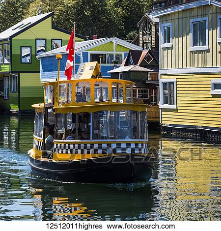 A small tour boat in Fisherman's Wharf in the Inner Harbour of Victoria, Vancouver Island; Victoria, British Columbia, Canada View Large Photo Image Stock Photograph - A small tour boat in Fisherman's Wharf in the Inner Harbour of Victoria, Vancouver Island; Victoria, British Columbia, Canada. Fotosearch