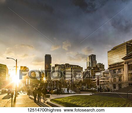 A street scene in Vancouver at sunset with pedestrians and buildings reflecting sunlight; Vancouver, British Columbia, Canada View Large Photo Image Stock Photograph - A street scene in Vancouver at sunset with pedestrians and buildings reflecting sunlight; Vancouver, British Columbia, Canada. Fotosearch