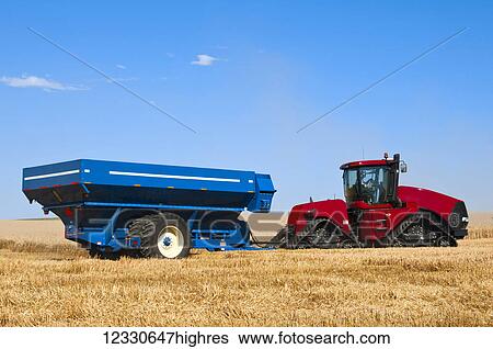 Stock Photograph - A Tractor Pulled Grain Cart On A Harvested Grain Field In Southeast Washington; Washington, United States Of America. Fotosearch