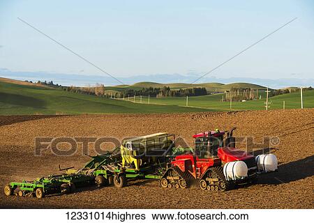 A Tractor Pulls Farming Equipment Over Farmland In The Palouse Region Of Eastern Washington; Washington, United States Of America View Large Photo Image Stock Photograph - A Tractor Pulls Farming Equipment Over Farmland In The Palouse Region Of Eastern Washington; Washington, United States Of America. Fotosearch