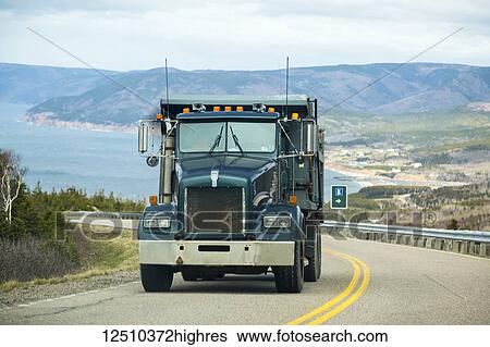 Stock Photograph - A transport truck makes it's way uphill on the highway along Cabot Trail; Cape Breton, Nova Scotia, Canada. Fotosearch