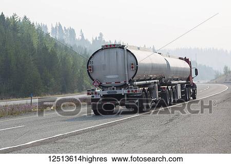 Stock Photograph - A transport truck on the highway driving west from Naramata to Vancouver on the Coquihalla Connector. There was a smoky haze due to the many forest fires burning; British Columbia, Canada. Fotosearch