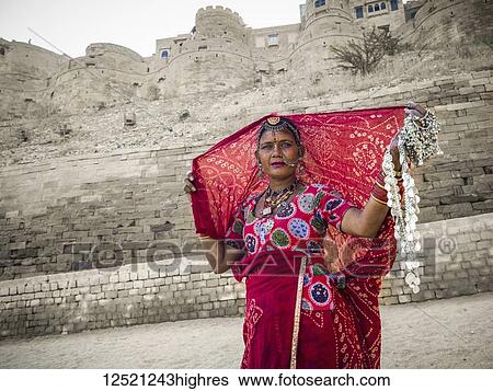 Stock Photograph - A woman in colourful traditional Indian clothing selling jewelry, Jaisalmer Fort; Jaisalmer, Rajasthan, India. Fotosearch
