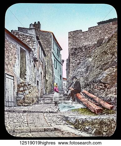 A young girl stands talking to a senior man, hand coloured, circa 1900; Eze, Alpes-Maritimes Department, France View Large Photo Image Stock Photograph - A young girl stands talking to a senior man, hand coloured, circa 1900; Eze, Alpes-Maritimes Department, France. Fotosearch