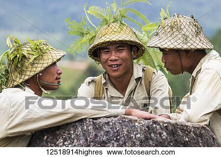 Stock Photograph - Actors dressed as Pathet Lao soldiers in traditional costume at Site 2, Plain of Jars; Xiangkhouang, Laos. Fotosearch