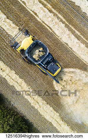 Aerial view directly above a combine collecting lines of cut grain; Beiseker, Alberta, Canada View Large Photo Image Stock Photograph - Aerial view directly above a combine collecting lines of cut grain; Beiseker, Alberta, Canada. Fotosearch