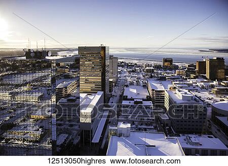 Aerial view of glass facade office buildings in downtown Anchorage, Cook Inlet in the background, snow covering the roofs throughout the city, South-central Alaska in winter; Anchorage, Alaska, United States of America View Large Photo Image Stock Photograph - Aerial view of glass facade office buildings in downtown Anchorage, Cook Inlet in the background, snow covering the roofs throughout the city, South-central Alaska in winter; Anchorage, Alaska, United States of America. Fotosearch