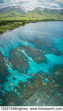 Stock Photograph - Aerial view of kayaks over the reefs off Olowalu, West Maui. Six photographs were combined for this final image; Lahaina, Maui, Hawaii, United States of America. Fotosearch