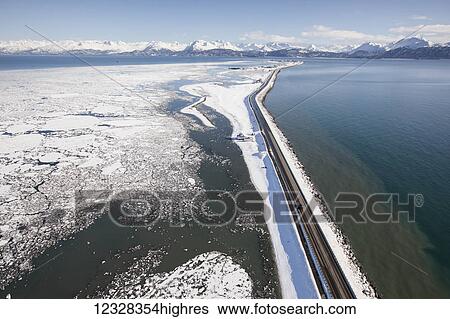 Stock Photograph - Aerial View Of The Homer Spit And Kenai Mountains In Winter, Southcentral Alaska, USA. Fotosearch
