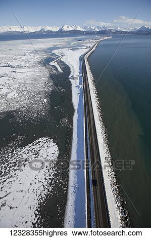 Stock Photograph - Aerial View Of The Homer Spit And Kenai Mountains In Winter, Southcentral Alaska, USA. Fotosearch