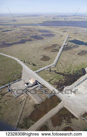 Stock Photograph - Aerial View, Oil Production, Pipeline, Prudhoe Bay Oil Field, North Slope, Alaska, Coastal Plane. Fotosearch