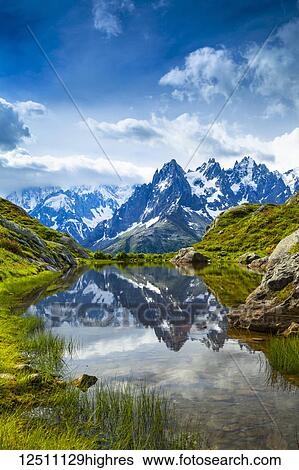 Aiguille des Charmoz, part of Aiguilles de Chamonix, reflects on Lac Flegere surrounded with green meadow, Aiguilles Rouges; Chamonix-Mont-Blanc, Haute-Savoie, France View Large Photo Image Stock Photograph - Aiguille des Charmoz, part of Aiguilles de Chamonix, reflects on Lac Flegere surrounded with green meadow, Aiguilles Rouges; Chamonix-Mont-Blanc, Haute-Savoie, France. Fotosearch