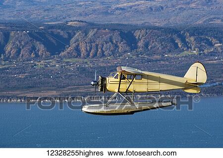 Stock Photograph - Air-To-Air View Of A 1933 Stinson Jr Sr Over Homer, Kenai Peninsula, Southcentral Alaska, USA. Fotosearch