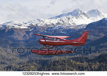 Stock Photograph - Air-To-Air View Of A Cessna 206 Stationair Floatplane Next To The Kenai Mountains, Kachemak Bay State Park, Southcentral Alaska, USA. Fotosearch