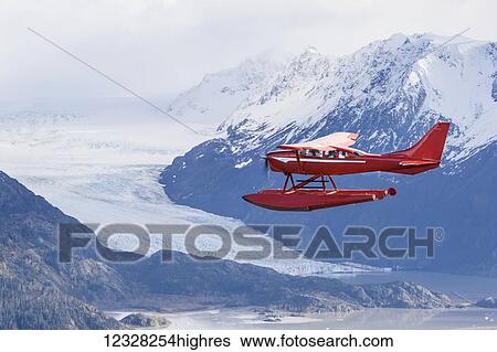Stock Photograph - Air-To-Air View Of A Cessna 206 Stationair Floatplane Next To The Kenai Mountains, Kachemak Bay State Park, Southcentral Alaska, USA. Fotosearch