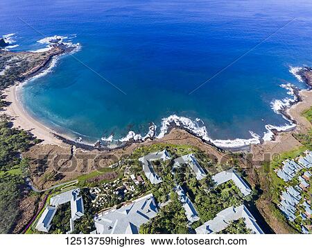 Stock Photograph - An aerial view of the golden beach and palm tree's at Hulopo'e Beach Park, and the Four Seasons resort at Manele Bay; Wailuku, Lanai, Hawaii, United States of America. Fotosearch