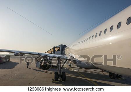 An Airplane Loading Passengers On The Tarmac At Frankfurt Airport; Frankfurt, Germany View Large Photo Image Stock Photograph - An Airplane Loading Passengers On The Tarmac At Frankfurt Airport; Frankfurt, Germany. Fotosearch