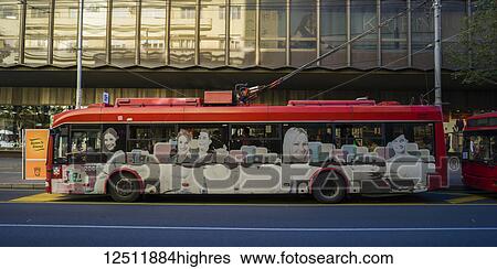 An electric bus on the street with artwork on the side depicting people's faces; Belgrade, Vojvodina, Serbia View Large Photo Image Stock Photograph - An electric bus on the street with artwork on the side depicting people's faces; Belgrade, Vojvodina, Serbia. Fotosearch