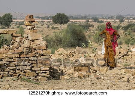 An Indian woman standing in Thar Desert; Jaisalmer, Rajasthan, India View Large Photo Image Stock Photograph - An Indian woman standing in Thar Desert; Jaisalmer, Rajasthan, India. Fotosearch