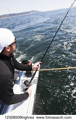 Stock Photograph - Angler halibut fishing in Kachemak Bay, South-central Alaska; Homer, Alaska, United States of America. Fotosearch