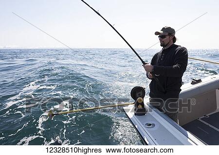 Stock Photograph - Angler halibut fishing in Kachemak Bay, Homer, South-central Alaska; Homer, Alaska, United States of America. Fotosearch