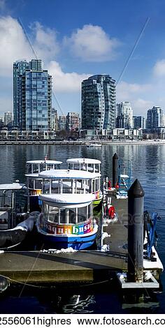 Stock Photograph - Aqua buses in the harbour of Granville Island; Vancouver, British Columbia, Canada. Fotosearch