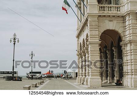 Stock Photograph - Architecture and street life with vehicles and pedestrians; Italy. Fotosearch