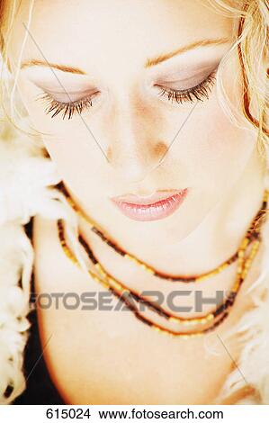 Picture - Attractive woman wearing beads. Fotosearch