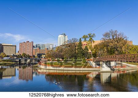 Stock Photograph - Autumn view of Rochester, Minnesota skyline along Zumbro River with Canada Geese (Branta canadensis), home of the Mayo Clinic; Rochester, Minnesota, United States of America. Fotosearch
