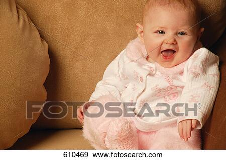 Baby girl smiles in chair View Large Photo Image Stock Photo - Baby girl smiles in chair. Fotosearch